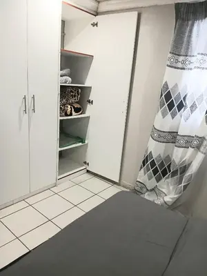 a room with a closet with a curtain in it at Tonta house in Pretoria