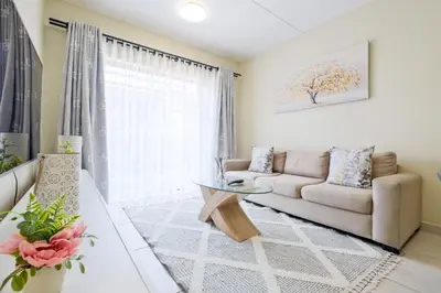 a living room with a couch and a table at Prime Ridge in Midrand