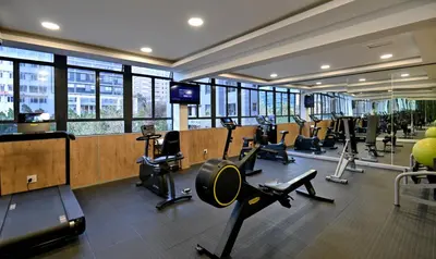 a gym with many treadmills and machines in a building at Hotels Near OR Tambo Airport Booked Easy in Johannesburg