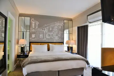 a bedroom with a large bed and a large window at Hotels Near OR Tambo Airport Booked Easy in Johannesburg