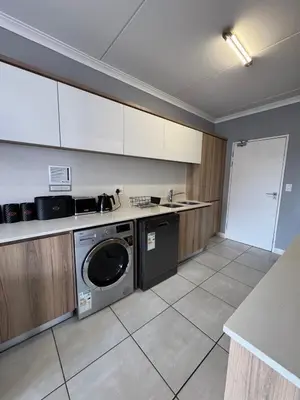 a kitchen with a washer and dryer in it at Lagoon lounge - The blyde crystal Lagoon in Pretoria
