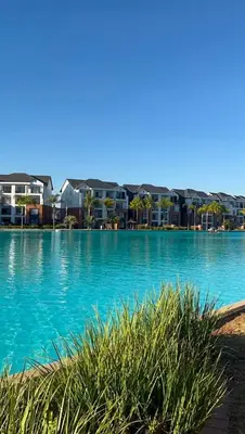 a large body of water with buildings in the background at Lagoon lounge - The blyde crystal Lagoon in Pretoria