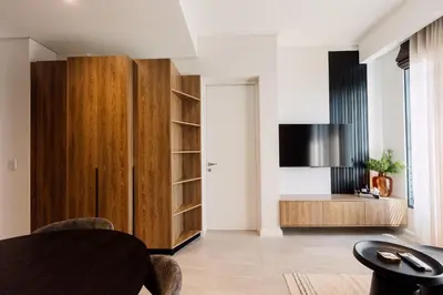 a living room with a wooden cabinet and a table at 532 Menlyn Maine in Pretoria