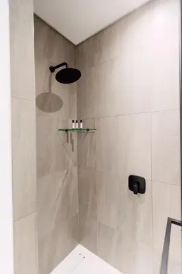 a shower with a glass shelf in a bathroom at 532 Menlyn Maine in Pretoria
