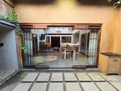 a living room with a table and a dining room at Lombard Manor in Pretoria