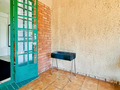 a briefcase sitting on a stool next to a wall at Tiny Home in Centurion