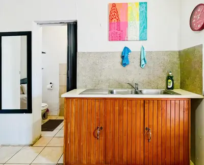 a kitchen with a sink and a mirror at Tiny Home in Centurion