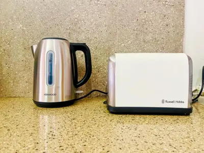a toaster and a toaster sitting on a counter at Tiny Home in Centurion
