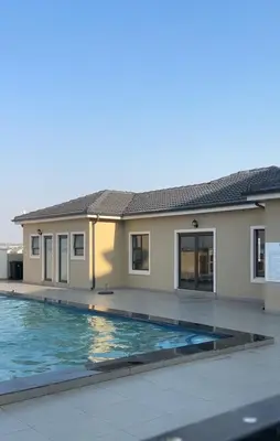 a house with a swimming pool in front of it at TruVela Executive Apartments - Midrand in Midrand