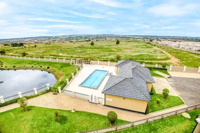 an aerial view of a house with a swimming pool at TruVela Executive Apartments - Midrand in Midrand