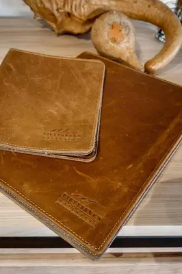a brown leather wallet sitting on top of a table at 57 Waterberg in Welgevonden Game Reserve