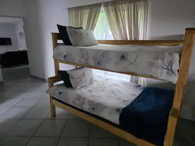 two bunk beds in a room with a window at The Pot in Pretoria