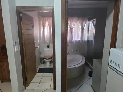 a bathroom with a tub and a toilet and a sink at The Pot in Pretoria