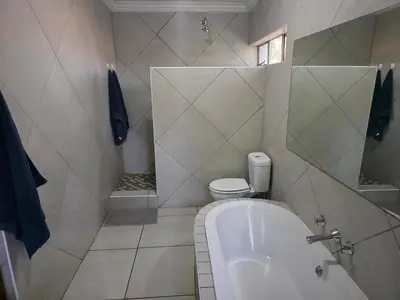 a bathroom with a bath tub and a toilet at The Pot in Pretoria