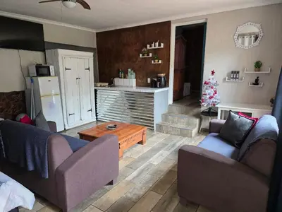 a living room with two couches and a christmas tree at The Pot in Pretoria