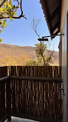 a wooden fence with a view of a field at 19 on Idwala, Mabalingwe Game Reserve in Warmbaths