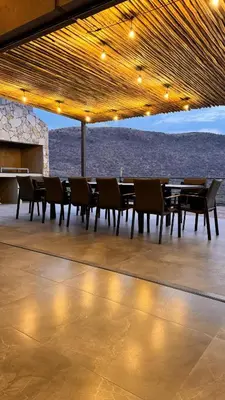 a dining area with tables and chairs and a view of the ocean at 19 on Idwala, Mabalingwe Game Reserve in Warmbaths