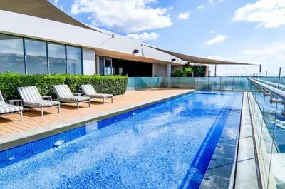 a swimming pool on the roof of a building at Trilogy studio apartment 831 in Pretoria
