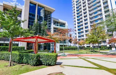 a red structure in a park in front of a building at Trilogy studio apartment 831 in Pretoria
