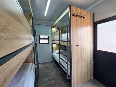 a small room with a bunk bed and a door at Beds Inn Midrand in Midrand