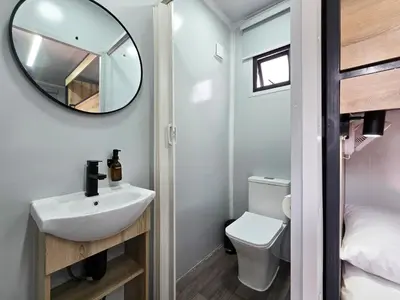 a small bathroom with a sink and a mirror at Beds Inn Midrand in Midrand