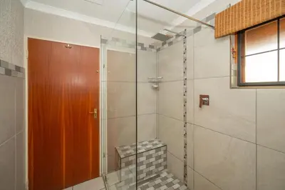 a bathroom with a shower with a glass door at Kruger Park Lodge Unit No 304 in Hazyview