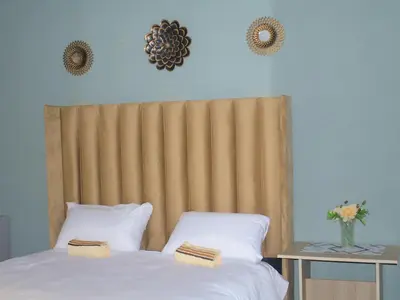 a bedroom with a bed with two pillows on it at Mahlako Guest Lodge in Polokwane