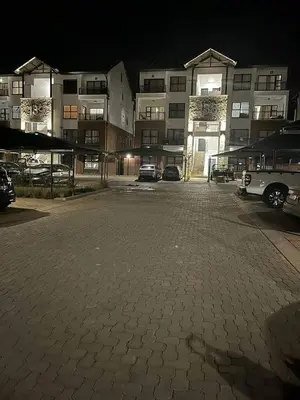 a parking lot in front of a building at night at The Blyde Pretoria in Pretoria