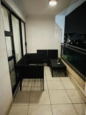 a balcony with two couches and a table on a building at The Blyde Pretoria in Pretoria