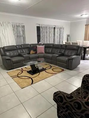 a black leather couch in a living room at The Blyde Pretoria in Pretoria