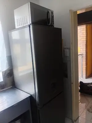 a refrigerator with its door open in a kitchen at Kings Lifestyle Apartments, City Retreat in Pretoria