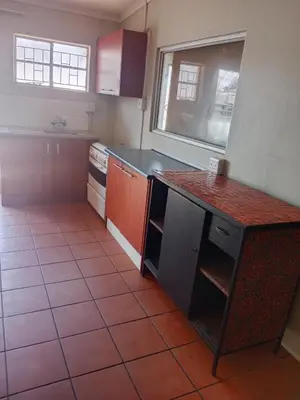 a kitchen with a red counter top in a room at Jakaranda house in Pretoria