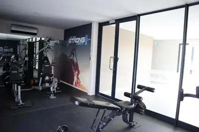 a fitness room with a gym with tread machines at Luxury Modern Apartment Prime Midrand Location in Midrand