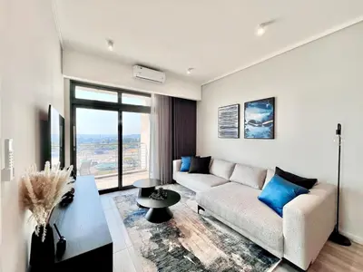 a living room with a couch and a table at The Trilogy Collection Luxury One Bedroom in Pretoria