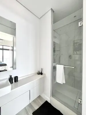 a bathroom with a glass shower and a sink at The Trilogy Collection Luxury One Bedroom in Pretoria