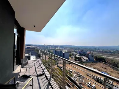 a balcony with a bench and a view of a city at The Trilogy Collection Luxury One Bedroom in Pretoria