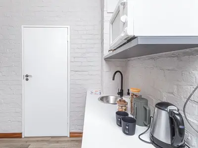 a white kitchen with a sink and a counter top at Links & Lavender in Centurion