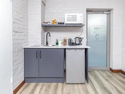 a small kitchen with a sink and a microwave at Links & Lavender in Centurion