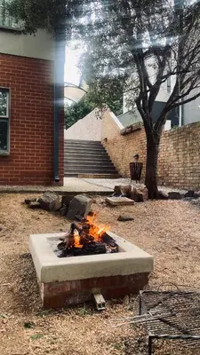 a fire pit in a yard next to a building at Links & Lavender in Centurion