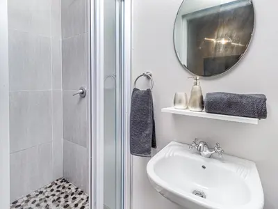 a bathroom with a sink and a mirror and a shower at Links & Lavender in Centurion