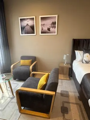 a bedroom with a bed and a couch and a chair at 1128 Executive Studio, The Capital Triology in Pretoria