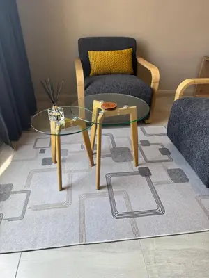 a living room with a glass table and a chair at 1128 Executive Studio, The Capital Triology in Pretoria