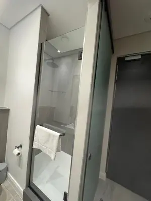 a shower with a glass door in a bathroom at 1128 Executive Studio, The Capital Triology in Pretoria
