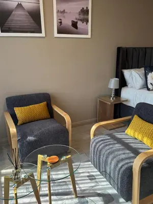 a living room with a couch and a chair and a table at 1128 Executive Studio, The Capital Triology in Pretoria