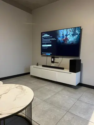 a living room with a large tv on a wall at The luxury IN waterfall Midrand in Midrand