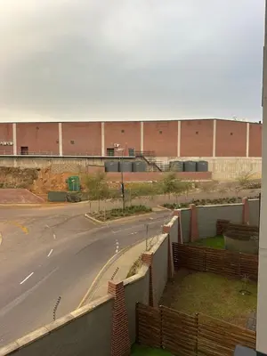 an empty street in front of a building at The luxury IN waterfall Midrand in Midrand
