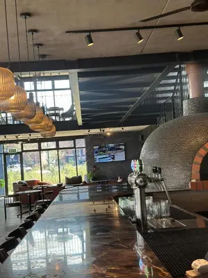 a restaurant with a bar with tables and chairs at The luxury IN waterfall Midrand in Midrand