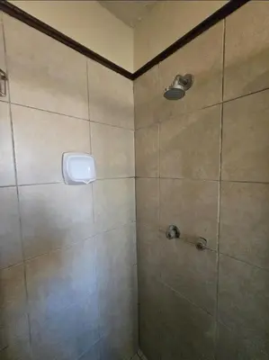 a bathroom with a shower with a tiled shower at THE Y's HOME in Centurion