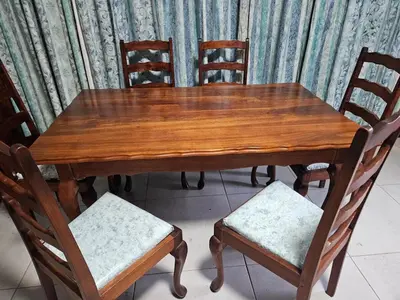 a wooden table with two chairs and a wooden table and chairs at Luxury Meets Convenience Near City & Travel Links in Pretoria
