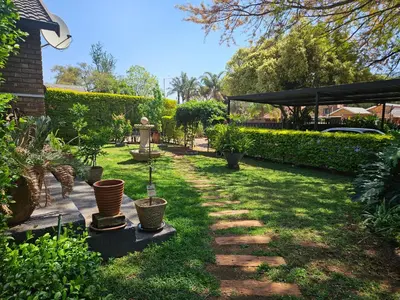 a garden with plants and a walkway at Luxury Meets Convenience Near City & Travel Links in Pretoria